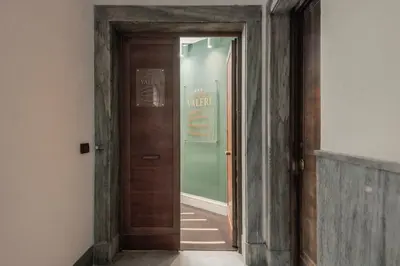 an empty hallway with a wooden door in a room at Hotel Valerì in Rome