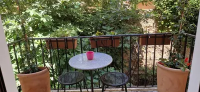 a table with a red cup sitting on a balcony at Hotel Valerì in Rome