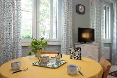 a dining room table with a yellow table cloth at Olimpico Apartment Flaminio in Rome