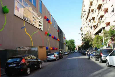 a street with cars parked on the side of a building at B&B Di Leo in Rome