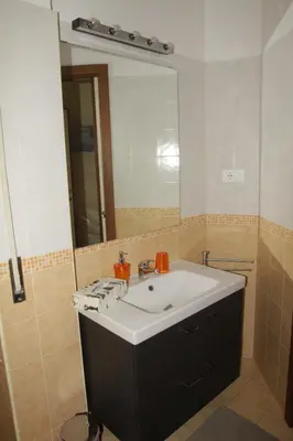 a bathroom with a sink and a large mirror at B&B Di Leo in Rome