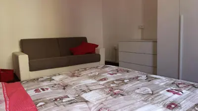 a bedroom with a bed and a couch in it at DaMa Domus in Rome