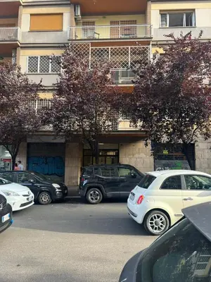 a parking lot with cars parked in front of a building at Matilda House Trastevere 8 posti letto in Rome