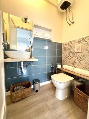 a bathroom with a white toilet and a sink at Matilda House Trastevere 8 posti letto in Rome