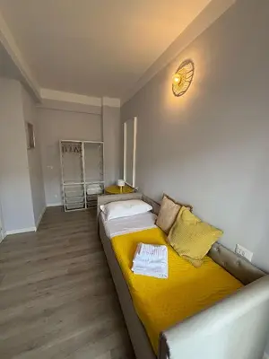 a bedroom with a yellow bed in a room at Matilda House Trastevere 8 posti letto in Rome