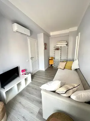 a living room with a couch and a flat screen tv at Matilda House Trastevere 8 posti letto in Rome