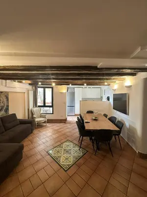 a living room with a table and a couch at La Maison di Trastevere in Rome