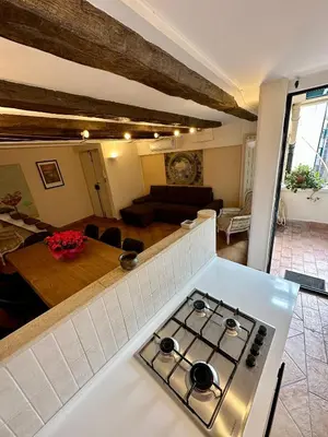 a kitchen and living room with a stove top oven at La Maison di Trastevere in Rome