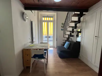 a living room with a table and a couch at Studio flat ultimo piano in centro in Rome