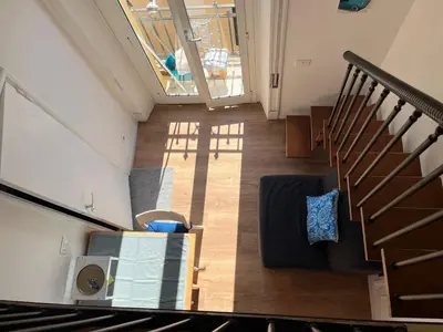 an overhead view of a living room with a table and stairs at Studio flat ultimo piano in centro in Rome