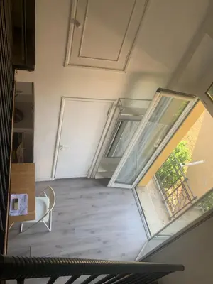 an empty room with a window and a chair at Studio flat ultimo piano in centro in Rome