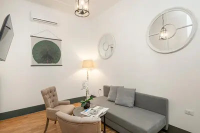 a living room with a couch and a table and chairs at Angelina Dimora Contemporanea in Rome