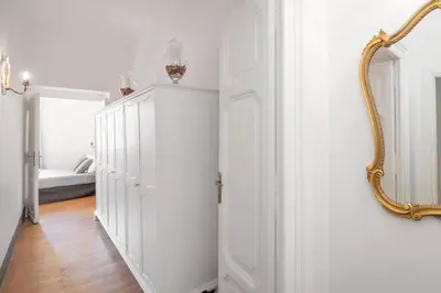 a hallway with a mirror and a white closet at Angelina Dimora Contemporanea in Rome