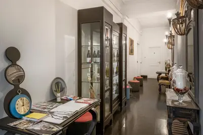 a room with a clock and some tables and chairs at Angelina Dimora Contemporanea in Rome