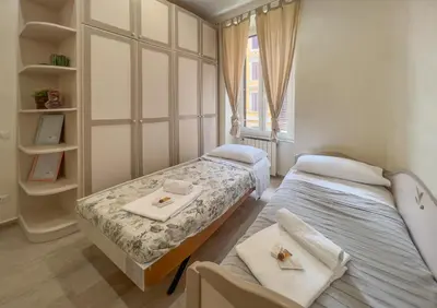a bedroom with two beds and a window at AD MAIORA SUITE in Rome