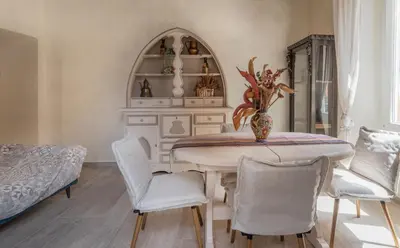 a dining room with a table and chairs at AD MAIORA SUITE in Rome