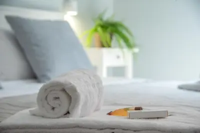 a towel sitting on a bed with a piece of food at AD MAIORA SUITE in Rome