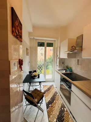 a kitchen with a table and a chair in it at Vatican Inside House in Rome