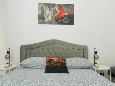 a bedroom with a bed with a motorcycle on the wall at Vatican Inside House in Rome