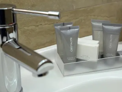 a bathroom sink with a container ofodorizers on it at Piccolo di Piazza di Spagna Suites in Rome