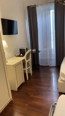 a room with a desk with a computer and a chair at Piccolo di Piazza di Spagna Suites in Rome