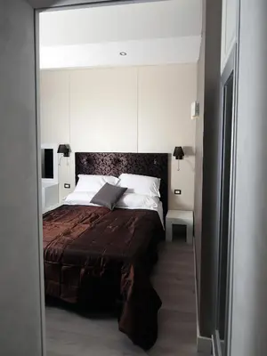 a bedroom with a large bed with a brown blanket at Piccolo di Piazza di Spagna Suites in Rome