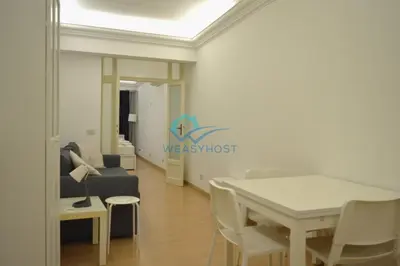 a living room with a table and a couch at Retreat in the Heart of Fori Imperiali in Rome
