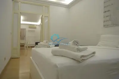 a room with three beds with towels on them at Retreat in the Heart of Fori Imperiali in Rome