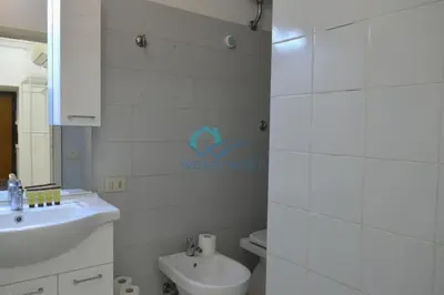 a white bathroom with a sink and a toilet at Retreat in the Heart of Fori Imperiali in Rome
