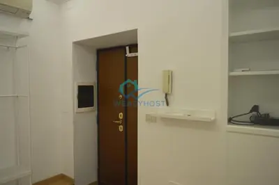 a door in a room with a phone on the wall at Retreat in the Heart of Fori Imperiali in Rome