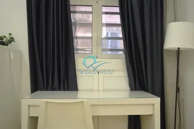 a desk in a room with a window at Retreat in the Heart of Fori Imperiali in Rome