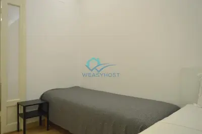 a bed in a room with a westmost sign on the wall at Retreat in the Heart of Fori Imperiali in Rome