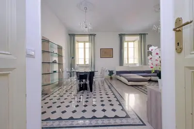 a living room with a table and a couch at Divine Vatican View Apartment in Rome