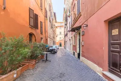 an alley with buildings and a car parked on a street at Thebestinrome Orbitelli in Rome