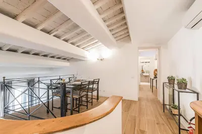 a kitchen and dining room with a table and chairs at Thebestinrome Orbitelli in Rome