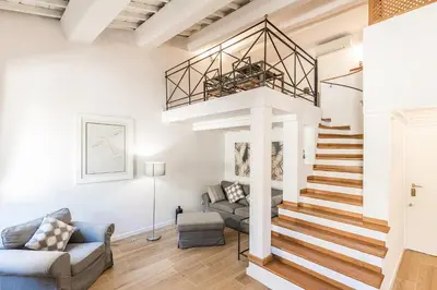 a living room with a staircase and a couch at Thebestinrome Orbitelli in Rome