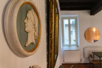 a picture of a woman on a wall next to a mirror at EasyTopStay - Castel Sant'Angelo Cosy Flat in Rome