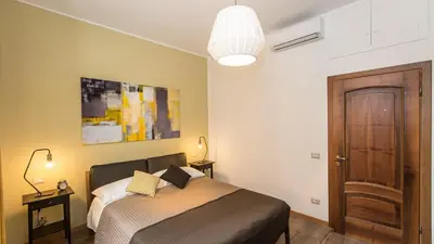 a bedroom with a bed and a wooden door at Saint Peter Prestigious by Rental in Rome in Rome