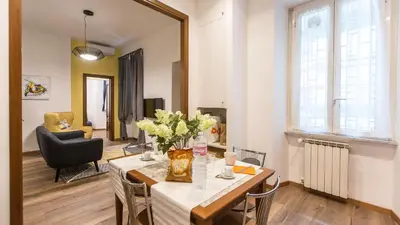a living room with a table with flowers on it at Saint Peter Prestigious by Rental in Rome in Rome