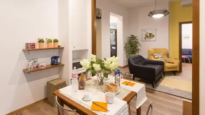 a living room with a table with flowers on it at Saint Peter Prestigious by Rental in Rome in Rome