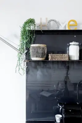 a shelf with baskets and plants on it at Mami's Home Monti in Rome