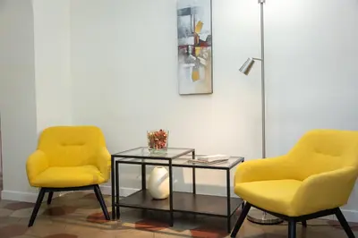 two yellow chairs and a glass table in a room at Principe Amedeo By Rental in Rome in Rome