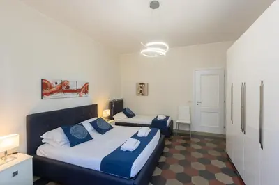 a bedroom with two beds in a room at Principe Amedeo By Rental in Rome in Rome