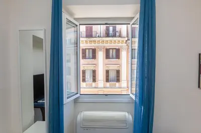 a window with a view of a building at Principe Amedeo By Rental in Rome in Rome