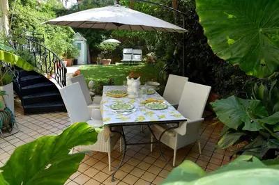 a table with chairs and an umbrella on a patio at Incanto Italiano in Rome
