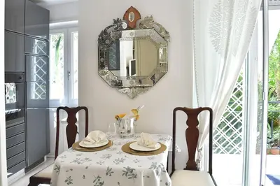 a white living room with a couch and a table at Incanto Italiano in Rome