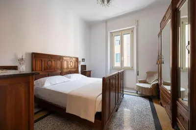a bedroom with a large bed and a bathroom at La Divina Duse in Rome