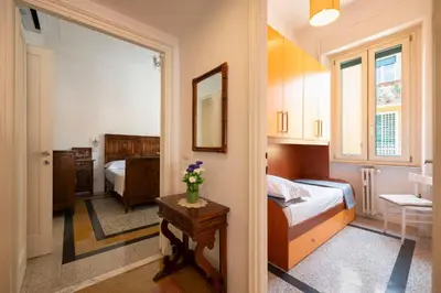 a small bedroom with a bed and a mirror at La Divina Duse in Rome