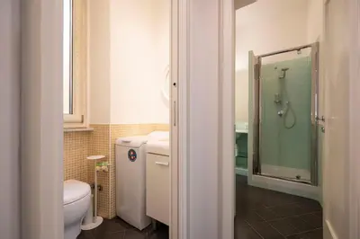 a bathroom with a toilet and a glass shower at La Divina Duse in Rome