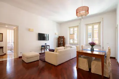 a living room with a white couch and a table at La Divina Duse in Rome